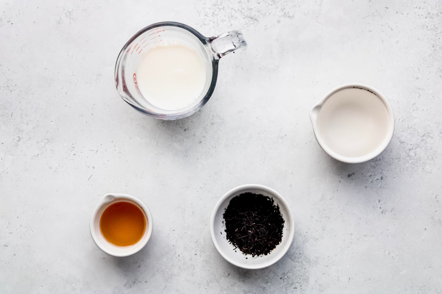 Glass mug of homemade creamy organic milk tea made with Yerba Buena Tea Co. loose leaf Assam black tea.