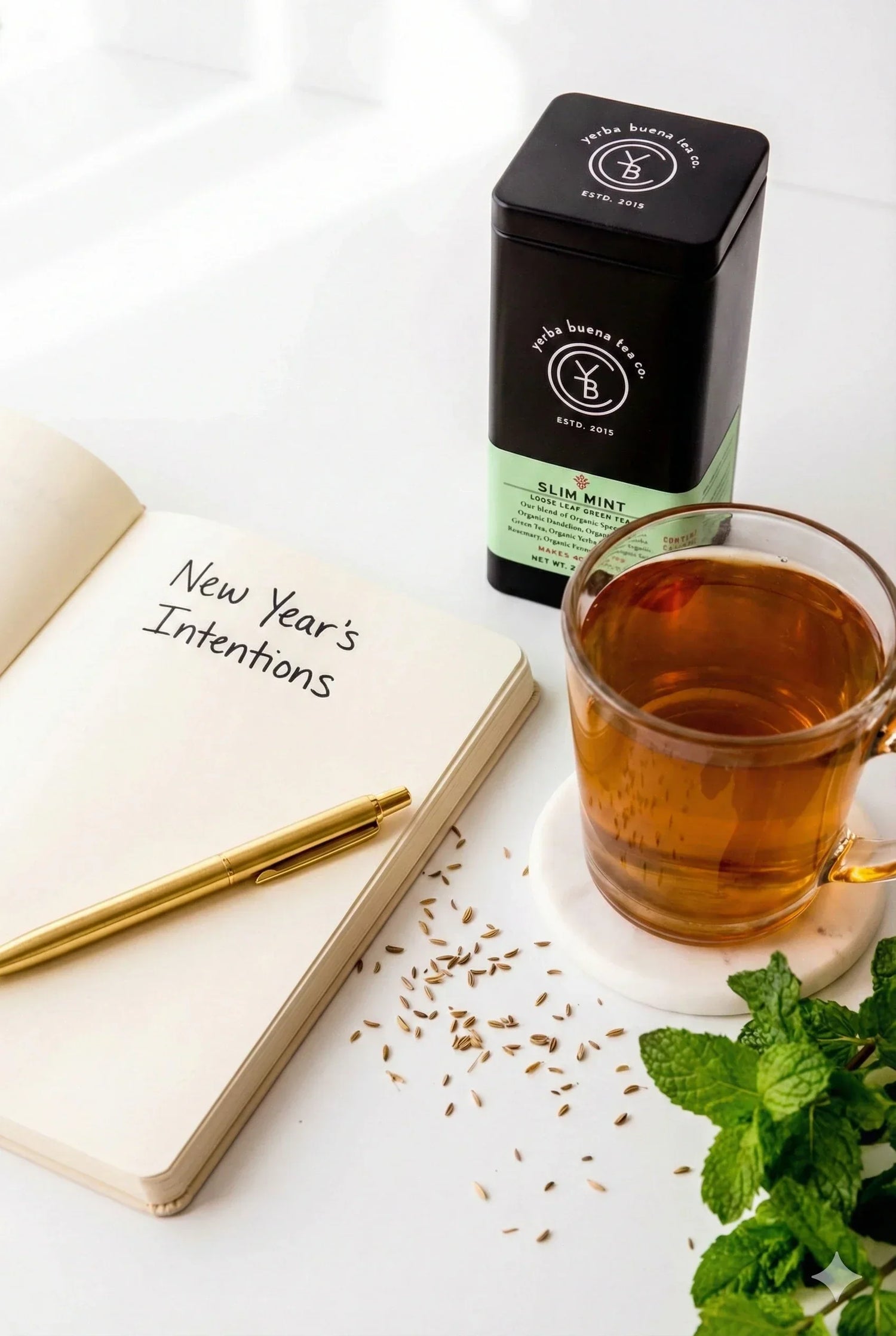 Organic green tea beside a journal of new year intentions, part of a simple morning tea ritual, by Yerba Buena Tea Co.