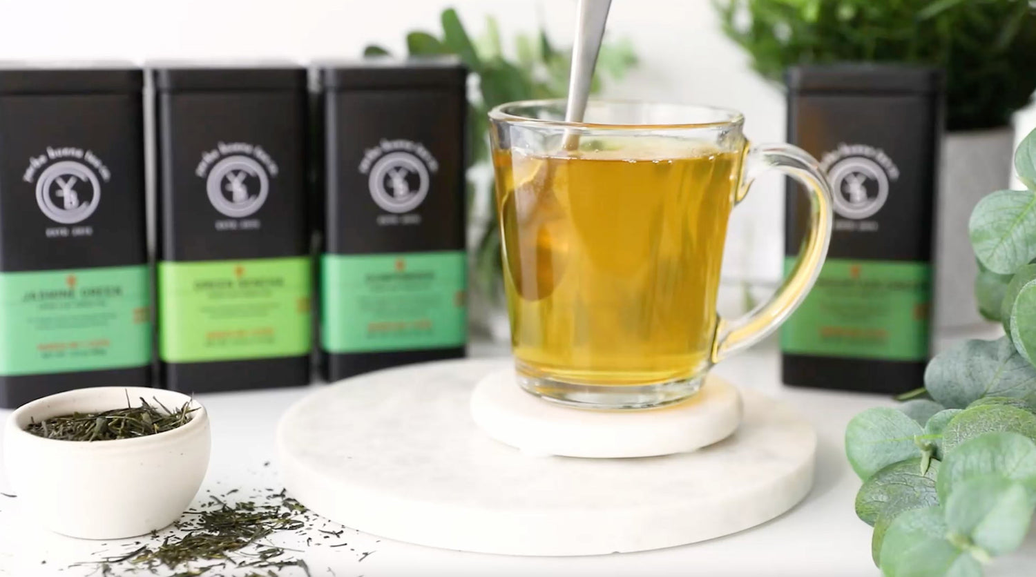 Stirring a smooth cup of organic green tea brewed at the right temperature, by Yerba Buena Tea Co.