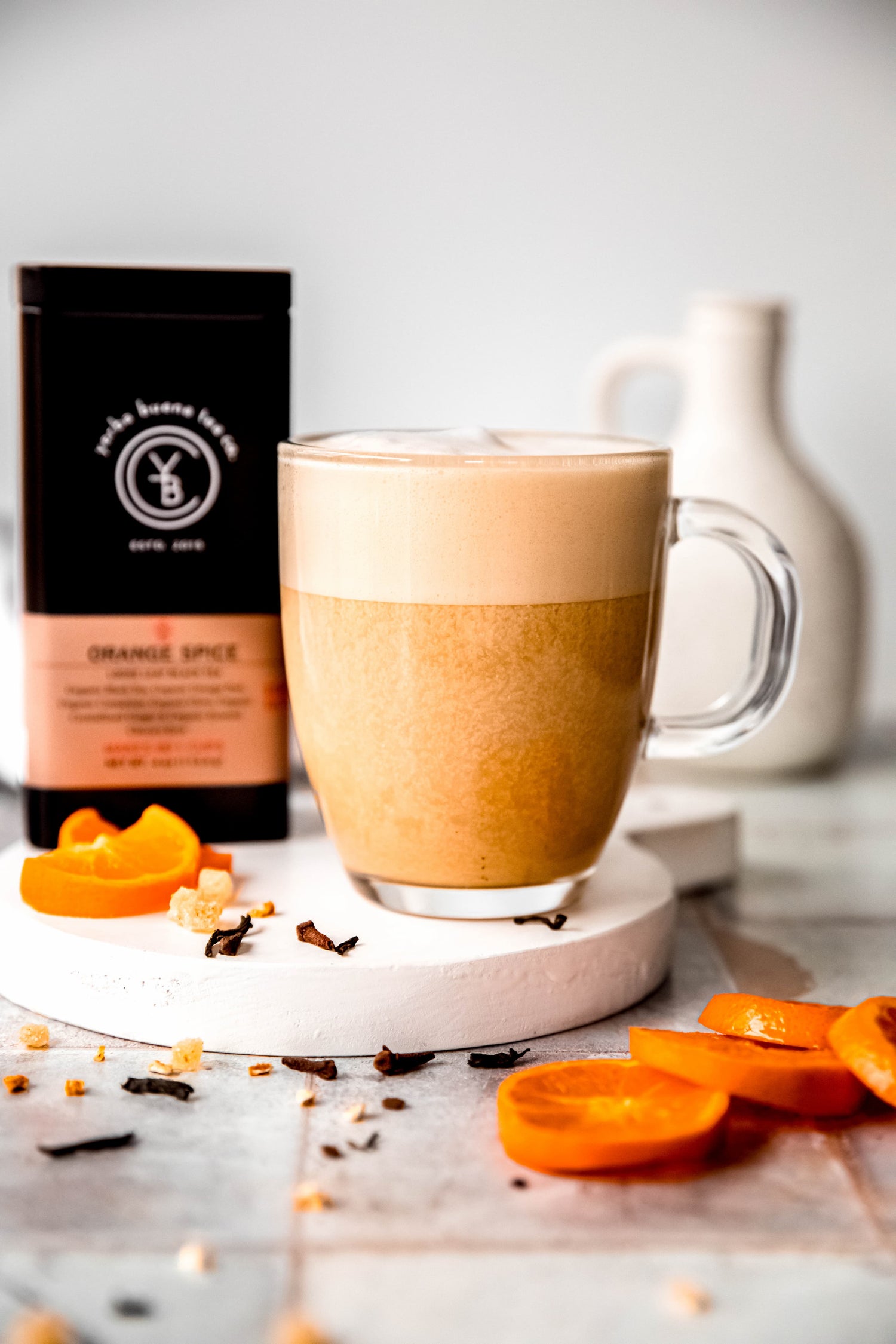 Foam-topped orange spice tea latte made with organic black tea, cinnamon, and orange peel, by Yerba Buena Tea Co.