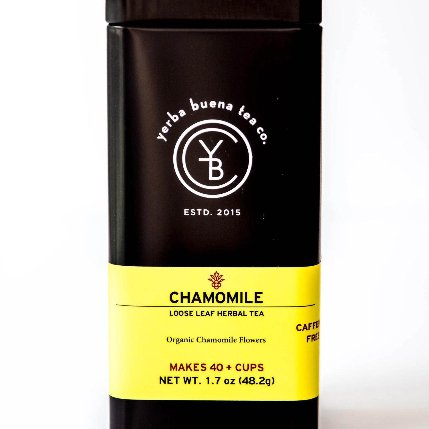 Chamomile loose leaf herbal tea in a black cylindrical canister with yellow label, by Yerba Buena Tea Company.