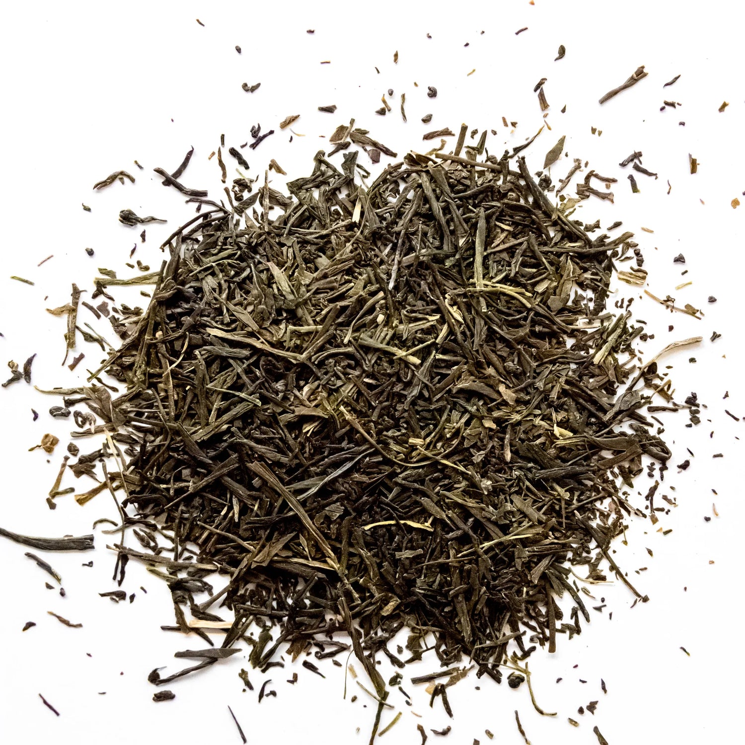 Loose leaf green sencha tea scattered on white background in natural dried leaf form, by Yerba Buena Tea Company.