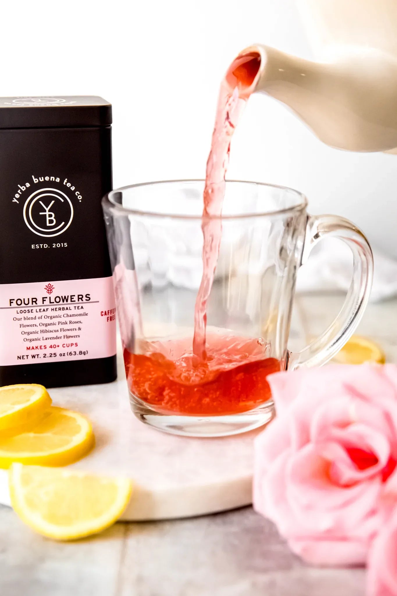 Spring tea collection with jasmine green tea, rose petals, and fresh mint leaves on a bright table