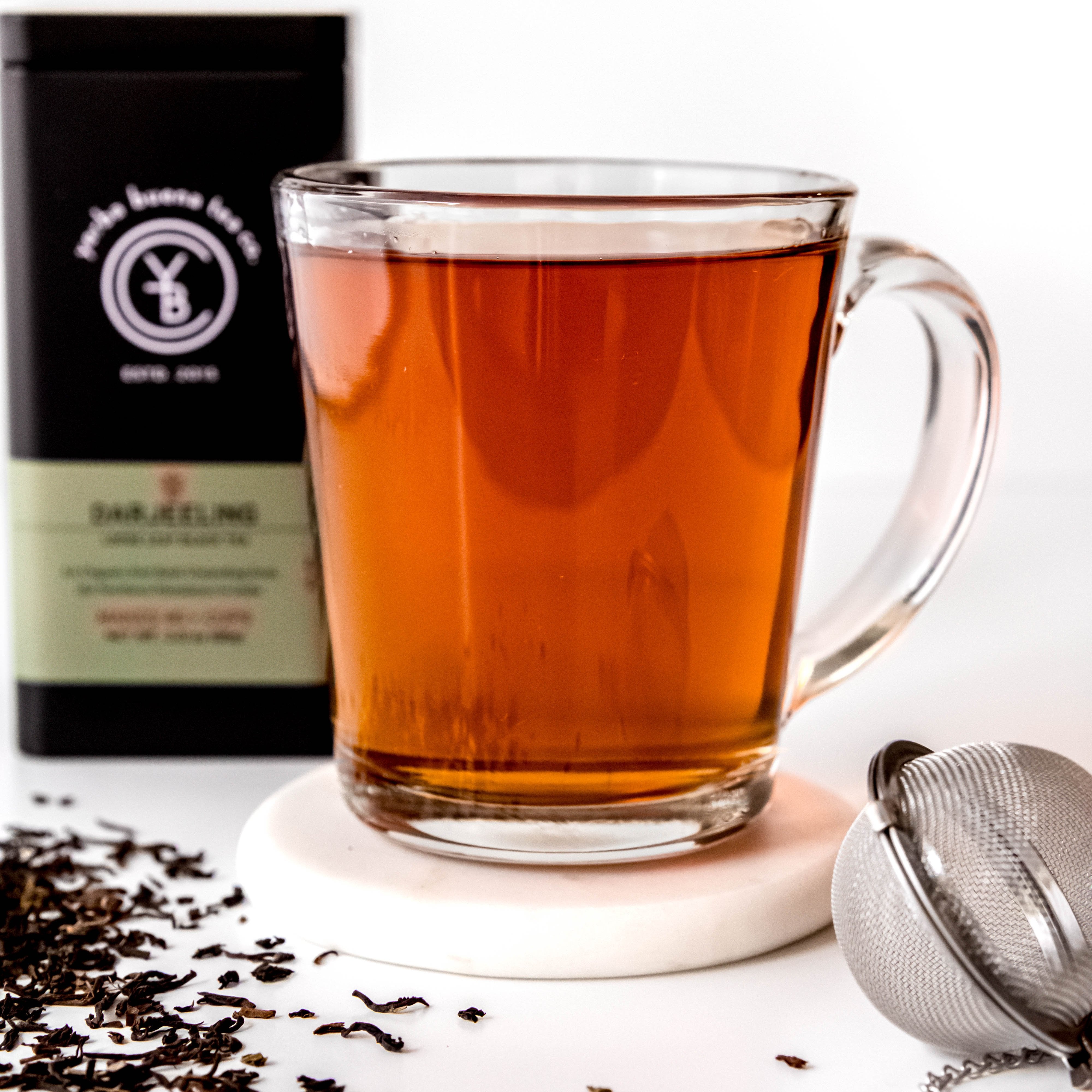 A cup of brewed Darjeeling tea from Yerba Buena Tea Co. Pale gold infusion with a smooth, refreshing finish.