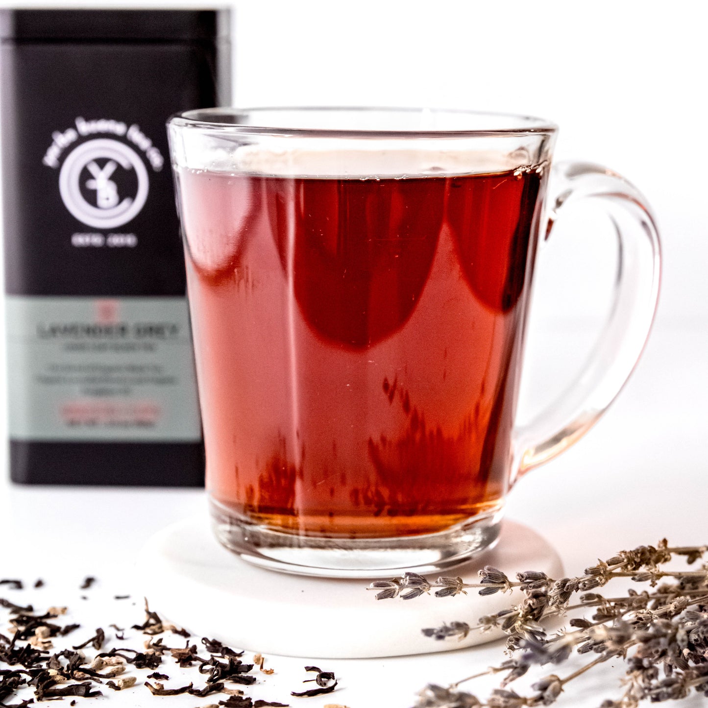 A cup of brewed Lavender Grey Tea with a rich amber hue, exuding a fragrant citrus and floral aroma.