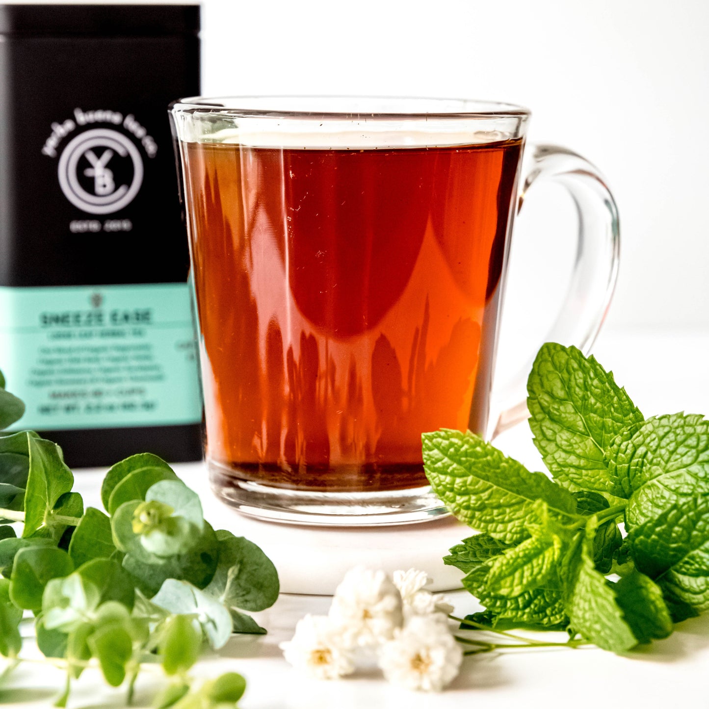 A cup of brewed Sneeze Ease tea with a light golden hue, exuding a refreshing minty aroma.