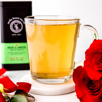 A cup of brewed Rose & Green tea with a light golden hue, exuding a delicate floral aroma.