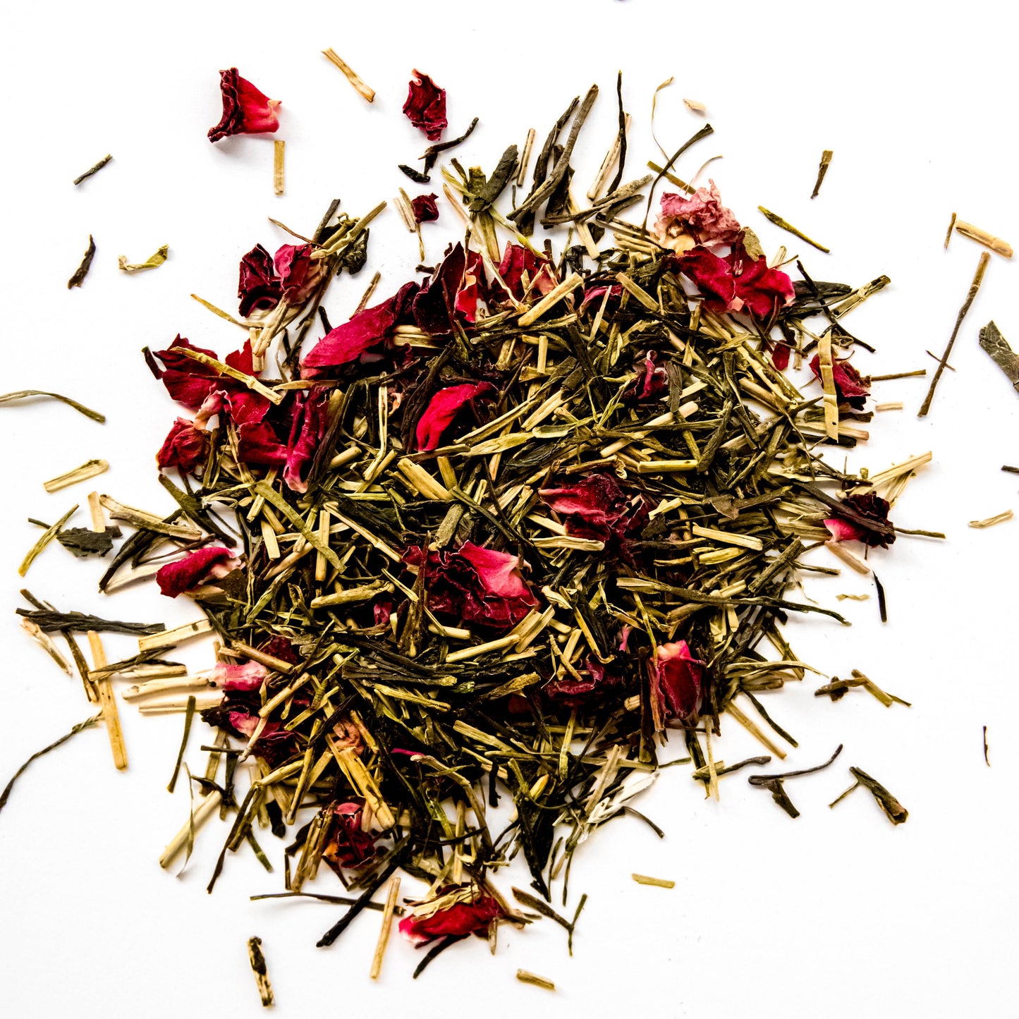 Loose leaf Rose & Green tea featuring green tea leaves interspersed with pink rose petals.