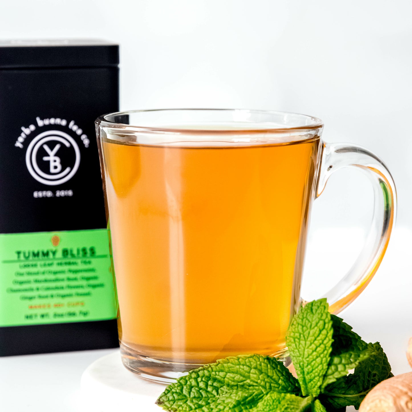 A cup of brewed Tummy Bliss tea from Yerba Buena Tea Co. A soothing caffeine-free herbal blend with organic peppermint, marshmallow root, chamomile, calendula, ginger, and fennel.