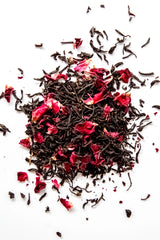 Loose leaf Bergamot Rose organic black tea displayed on a white background, featuring dark black tea leaves blended with dried rose petals and bergamot oil. A floral, citrus-kissed loose leaf black tea handcrafted in Oregon.