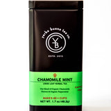 Chamomile Mint loose leaf herbal tea in a dark cylindrical canister with bright green label, by Yerba Buena Tea Company.