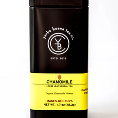 Chamomile loose leaf herbal tea in a black cylindrical canister with yellow label, by Yerba Buena Tea Company.