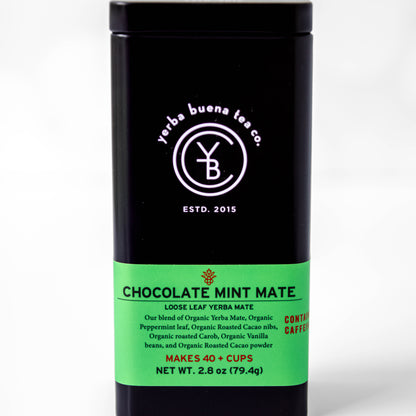 The Yerba Buena Tea Co. Chocolate Mint Mate tea tin, labeled with the blend’s name and ingredients, in a sleek black container with a green label. The text on the tin emphasizes that the blend is organic, contains caffeine, and makes 40+ cups, ideal for those seeking a flavorful and energizing tea experience.