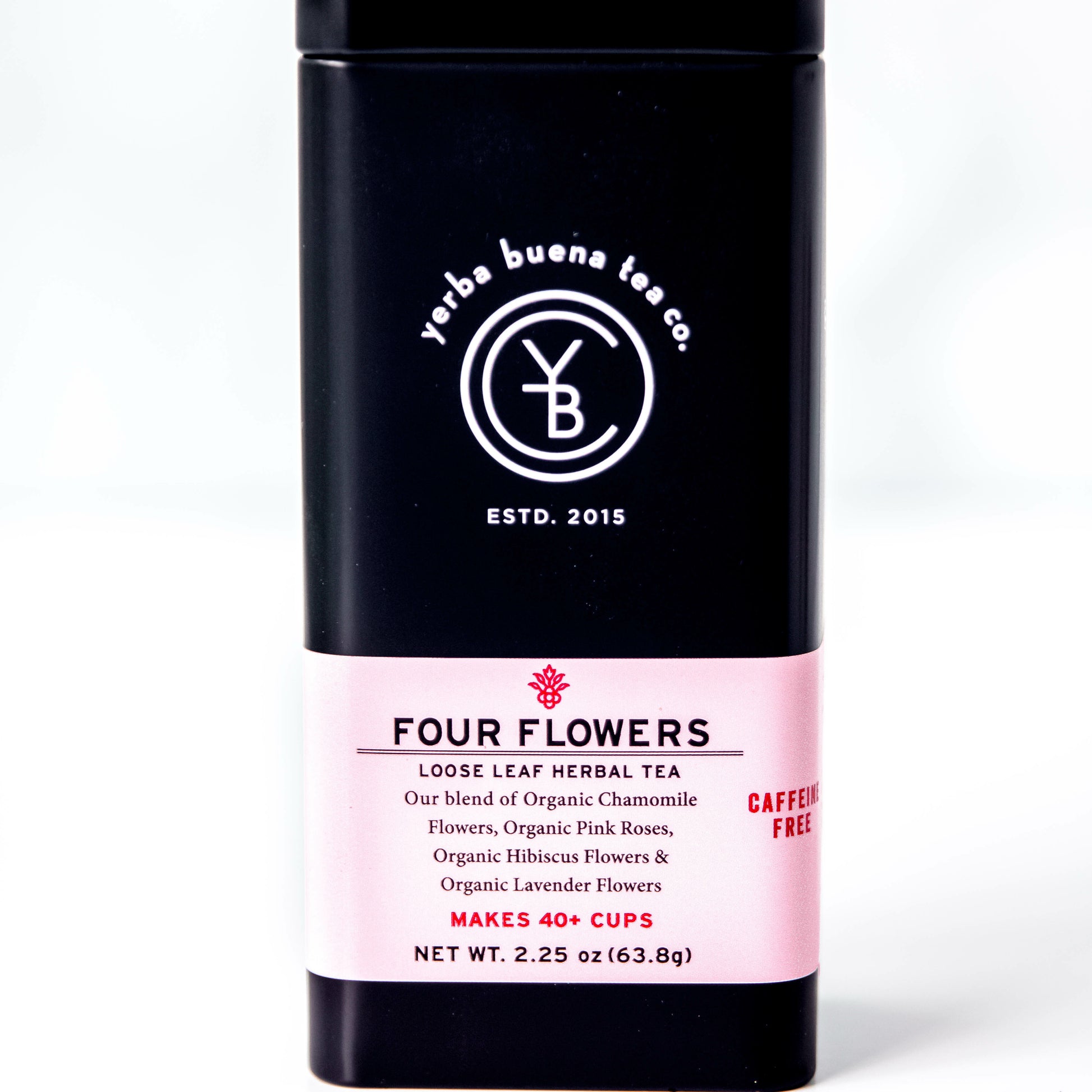 A black tin of Yerba Buena Tea Co.'s Four Flowers loose leaf herbal tea, labeled as caffeine-free and made with organic chamomile, pink roses, hibiscus, and lavender flowers, on a white background.