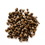 Jasmine Pearl loose leaf green tea with hand-rolled ball shapes displayed on white background, by Yerba Buena Tea Company.