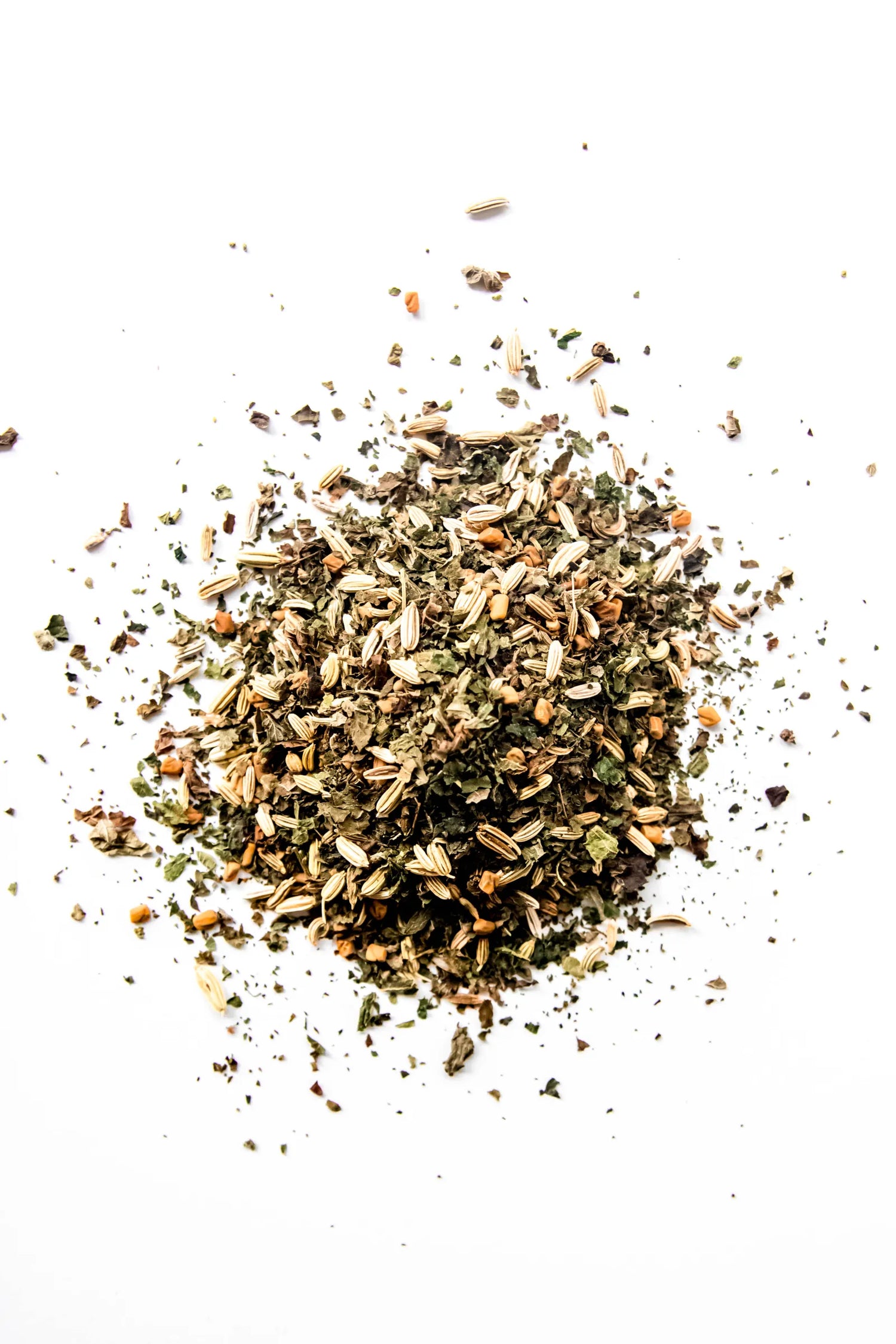 Loose leaf Leche de Mama organic herbal tea displayed on a white background, featuring fennel seed, fenugreek seed, lemon balm, and nettle. A caffeine-free loose leaf herbal blend handcrafted in Oregon.
