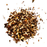 Loose leaf Maven Blend herbal tea blend scattered on white background with dark and light pieces, by Yerba Buena Tea Company.