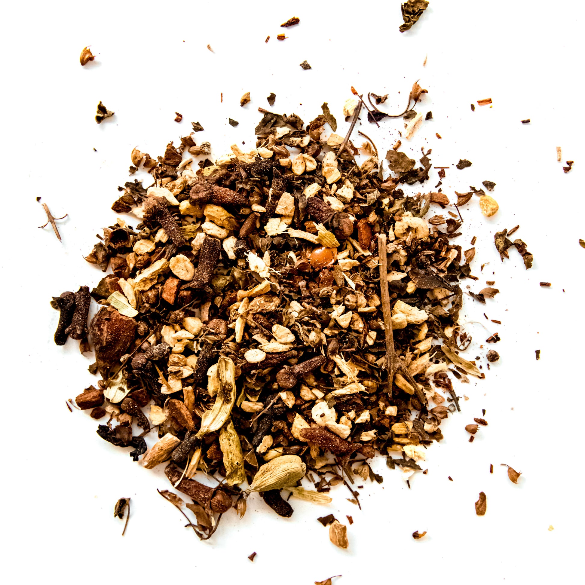 A close-up of the loose leaf blend of Maven Blend tea, showing the mix of organic rooibos, ginger, cardamom, cinnamon, cloves, nutmeg, holy basil, star anise, ashwagandha, acai berry powder, and coconut flakes against a white background.