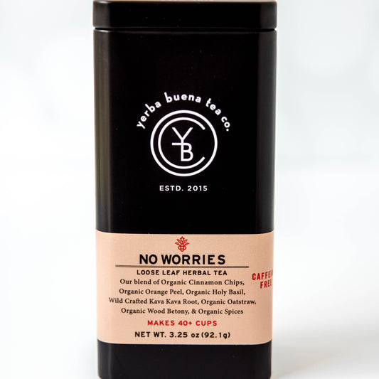 The Yerba Buena Tea Co. No Worries tea tin, labeled with the blend’s name and ingredients, in a sleek black container with a soft beige label. The text on the tin emphasizes that the blend is organic, caffeine-free, and makes 40+ cups, perfect for those seeking a calming and relaxing tea experience.