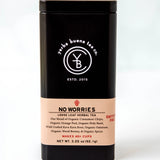 No Worries loose leaf herbal tea in a black cylindrical canister with cream label, by Yerba Buena Tea Company.