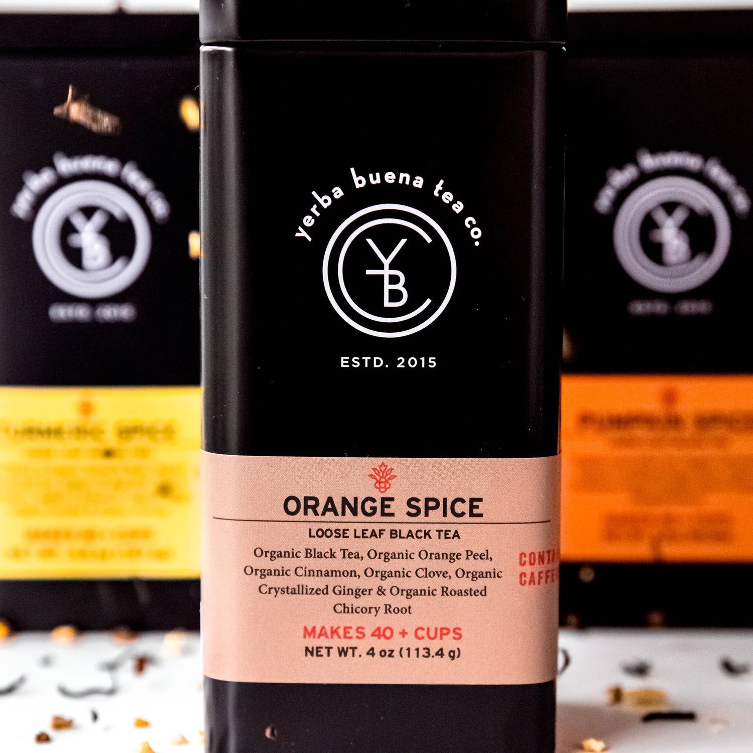 The Seasonal Spiced Gift Box featuring Orange Spice loose leaf black tea with clearly readable label showing organic ingredients and spice blend, by Yerba Buena Tea Company.