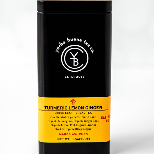 The Yerba Buena Tea Co. Turmeric Lemon Ginger tea tin, labeled with the blend’s name and ingredients, in a sleek black container with a yellow label. The text on the tin emphasizes that the blend is organic, caffeine-free, and makes 40+ cups, ideal for those seeking a vibrant, healthful tea.