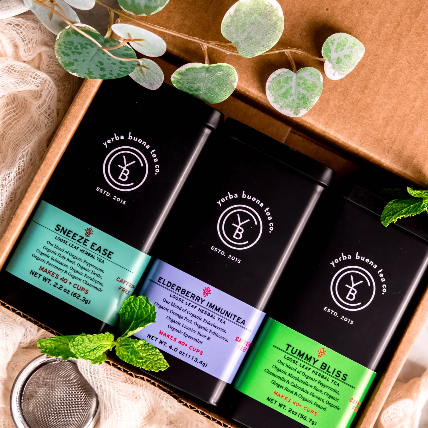 The Wellness Feel Better Box Set gift featuring three loose leaf herbal teas: Sneeze Ease, Elderberry Immunitea, and Tummy Bliss in branded pouches, by Yerba Buena Tea Company.