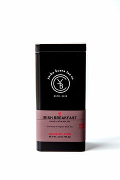 Front view of the signature black Yerba Buena Tea Co. tea tin for Irish Breakfast organic loose leaf black tea, featuring a dusty rose label with product details.